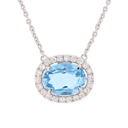 Oval Blue Topaz in White Gold Halo Necklace